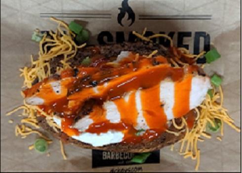Buffalo Chicken Baker · Giant baker with margarine, sour cream, cheddar cheese, green onion topped with smoked marinated chicken and buffalo sauce