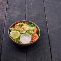 Garden Salad · A bed of fresh green salad topped with shredded carrots, red cabbage, and a hard boiled egg.