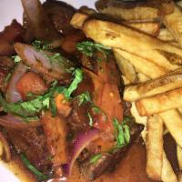 3. Lomo Saltado · Pepper steak sauteed with onions and tomatoes. Served with rice and french fries.
