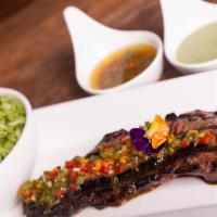 5. Entrana Muy Fina · Skirt steak marinated in fresh herbs, fri color chimicharri and green rice.