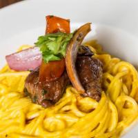 7. Tallarin a la Huancaina con Lomito Saltado · Spaghetti in yellow Peruvian pepper sauce with pepper steak, onions tomatoes in oyster sauce...