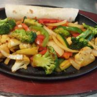 Veggie Fajitas · Mixed veggies sauteed with bell peppers and onions, served with rice and black beans, salsa,...
