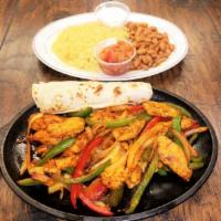 Chicken Fajitas · Sauteed bell peppers and onions, served with rice and beans, salsa, crema, and soft tortillas.