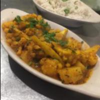 Aloo Gobi · Fresh cauliflower and potatoes cooked with onion, herbs, and spices. Vegetarian.