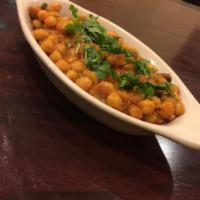 Chana Masala · Garbanzo beans cooked in with onions, tomatoes, and specials spices. Vegetarian.
