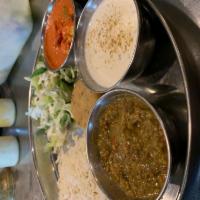 Special Veg Thali · Aloo tiki, veggie tikka masala, dal makhani, naan and rice, salad raita and kheer (rice pudd...