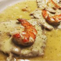 Veal alla Lenny · Sautéed in a champagne sauce, topped with provolone cheese, prosciutto & shrimp. Served with...