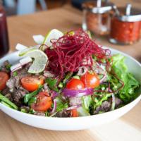 Lime Steak Salad · Grilled seasoned beef, beets, organic spring mix, cherry tomatoes, red onions, cilantro, and...