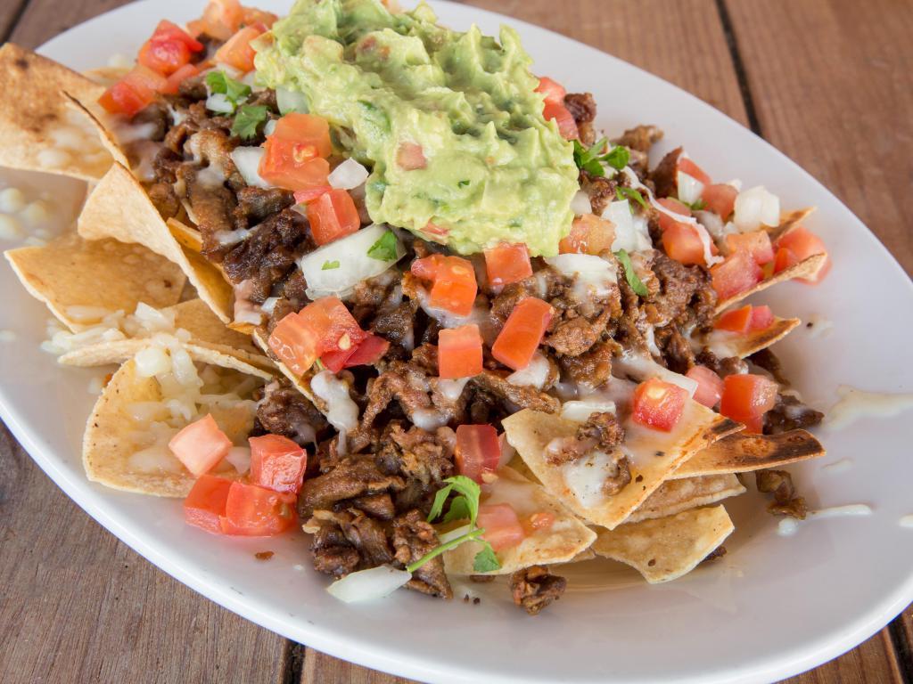 Super Nachos · Chips, topped with beans, cheese, choice of meat, onion, cilantro, tomato, guacamole, sour cream. 