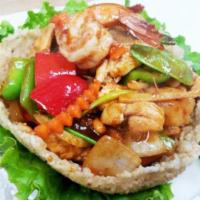 61. Bamboo Basket · Crispy noodle basket topped with shrimp, chicken, bell pepper, cashew nut, carrot, snow pea,...
