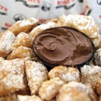 Zeppole · Bite-sized pieces of crispy dough tossed in powdered sugar and paired with rich Nutella haze...