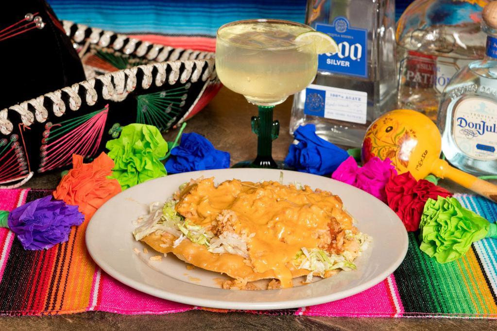 Bill's Special · A crispy tortilla layered with refried beans, chile verde, rice and chili con queso.