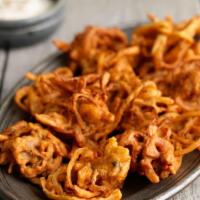 Onion Bhajia · Mixed onion and spinach fritters.