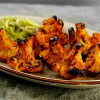 Tandoori Gobhi · Baked cauliflower florets coated with a special marinade and baked in the tandoor.