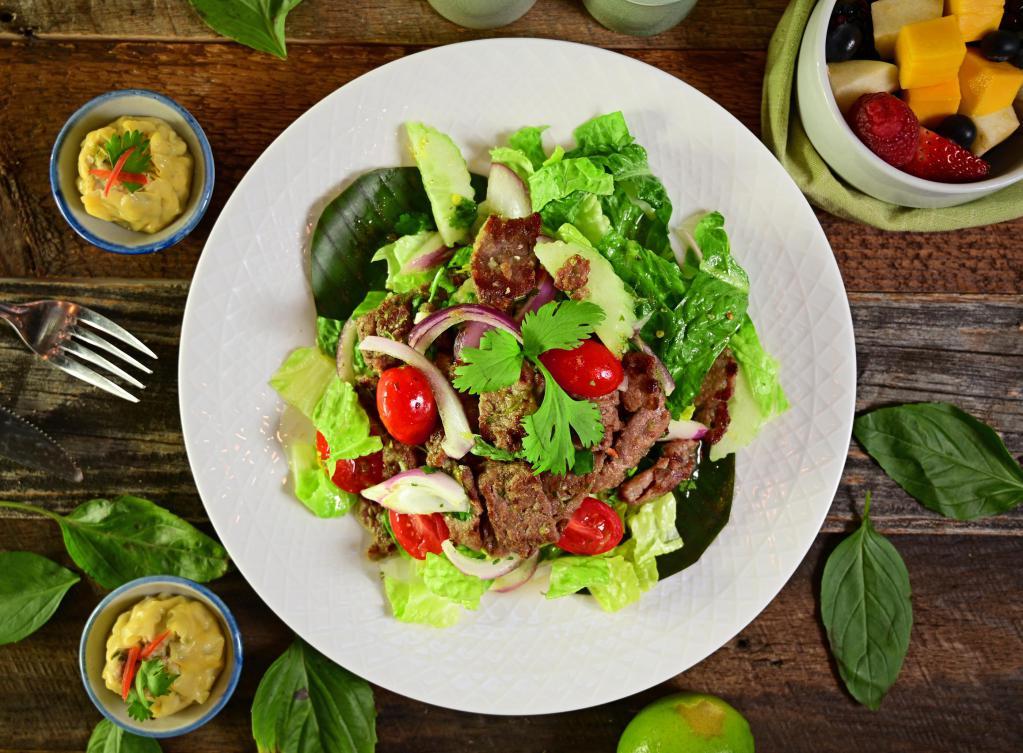 Beef Salad · Yum neau. Marinated grilled beef, cucumbers, onions, tomatoes and cilantro on a bed of lettuce. Spicy.