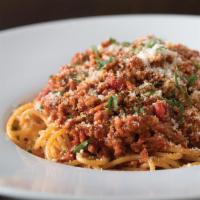Spaghetti Bolognese  · With Cremini mushrooms, sprinkled with scallions.