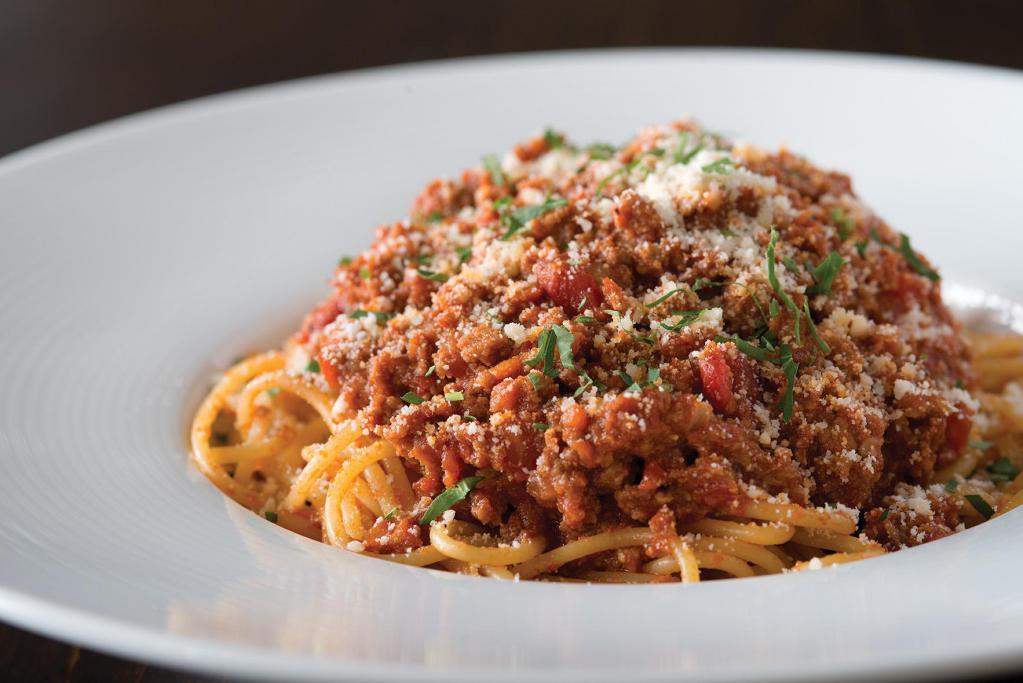 Spaghetti Bolognese  · With Cremini mushrooms, sprinkled with scallions.