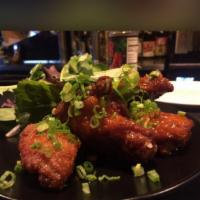 F11. Sriracha Fried Chicken · Fried chicken wings glazed with spicy homemade Sriracha sauce. Spicy.