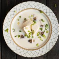 S2. Coconut Soup · The light creamy and sour taste of coconut milk and Thai herb broth comes with mushrooms. Gl...