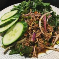 E32. Lucky Piggy · Larb. Spicy and sour ground pork salad mixed with Thai herbs, mint, scallion, red onion, and...