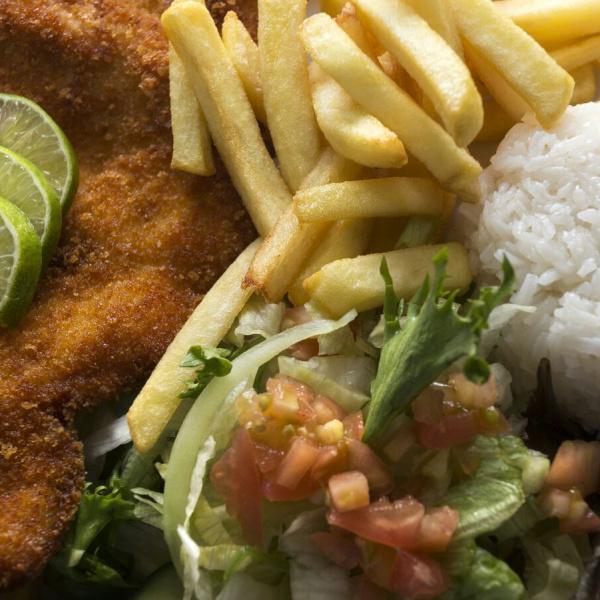 Milanesa de Pollo · Pounded chicken breast, lightly breaded and deep fried. Served with white rice, french fries and salad.