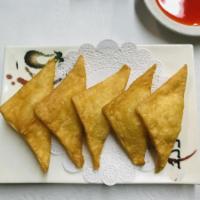 Crab Rangoon · Stuffed with imitation crab meat and cream cheese in a crispy triangle shell.