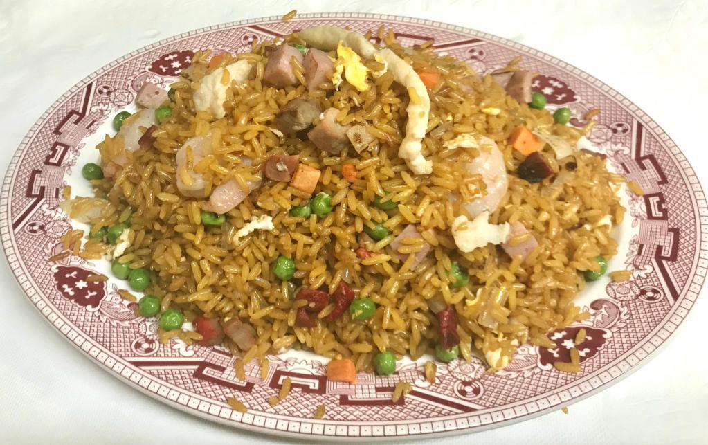 Special Fried Rice · Stir fried yellow rice with shrimp, white meat chicken, roast pork, ham, egg, onion, peas and carrots.