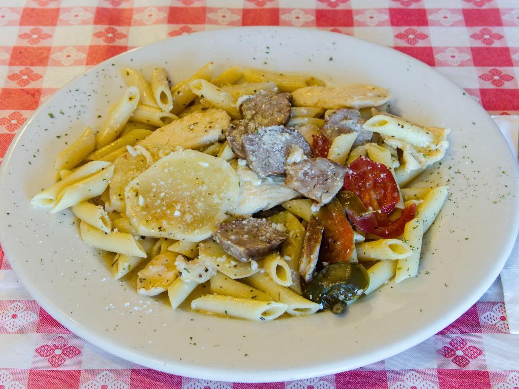 Pasta Scarpara · Tender pieces of chicken, Italian sausage, cherry peppers and potatoes sauteed in a herbal garlic and white wine sauce. Served with two homemade onion and garlic rolls.