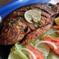 Fried Fish · Whole fried tilapia paired with the choice of 2 sides.