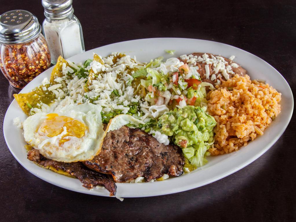 Chilaquiles with Eggs and Cecina Breakfast Platter · Chilaquiles with eggs and Cecina. Served with rice and refried beans.
