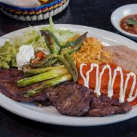 Tampiquena Dinner · Tampico club style steak. Served with salad, refried beans and rice.