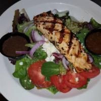 Salmon on the Green Salad · Salmon crusted in peppercorn and seared, served on top of mixed greens, fresh tomatoes, cucu...