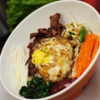 Bi Bim Bob · Assorted vegetable, beef and fried egg. Served with red chili sauce.