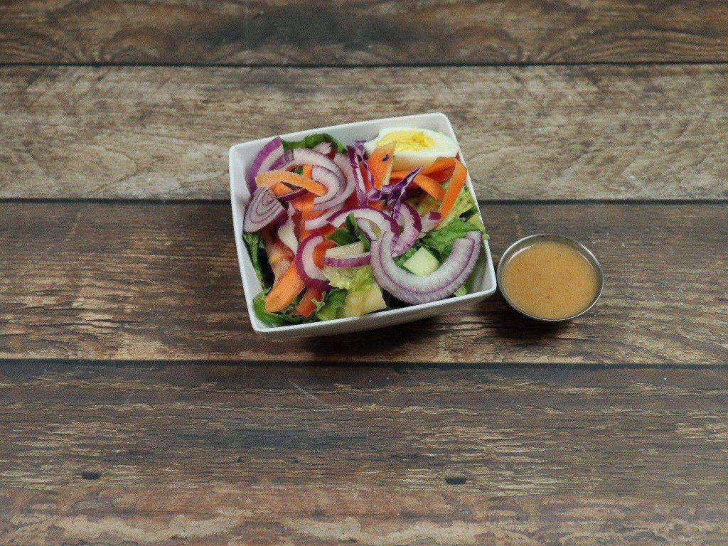 House Salad · Lettuce, tomato, cucumber, onion, egg, carrots and cabbage.