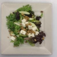 House Salad · Spring mix, Granny Smith apples, feta cheese and walnuts tossed in raspberry vinaigrette dre...