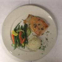 Roasted Salmon · Finished with a lemon caper sauce. Served with mashed potatoes and vegetable of the day.