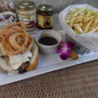 The Ultimate French Dip · Mais oui! Thinly sliced tri tip stacked high with creamy horseradish sauce, fried onions, Sw...