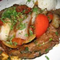 Bisteck Encebollado · Steak sauteed with onions, tomatoes and side of white long grain rice.
