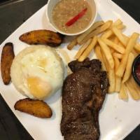 Bistek a la Pobre · Peruvian special steak with rice, egg, beans and fried bananas.