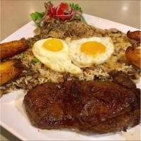 Tacu-Tacu con Carne · Rib-eye steak cut 9 oz. with a side of mixed fried beans and rice as a cake sauteed with oli...