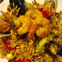 Chaufa de Mariscos · Our version of fried rice with shrimp, calamari, scallops, mussels, and crab nails. Sauteed ...