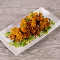 Onion Pakora · Thin sliced onions mixed with besan flour, spices and deep fried. Gluten free. Vegetarian.