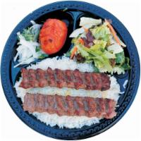 12. Beef Lula Kabob · Ground beef with onion and spices served with basmati rice, green salad, broiled tomato, sli...