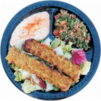26. Chicken Lula Kabob Salad · Ground chicken kabab over a bed of mixed lettuce, with hummus and tabbouleh.