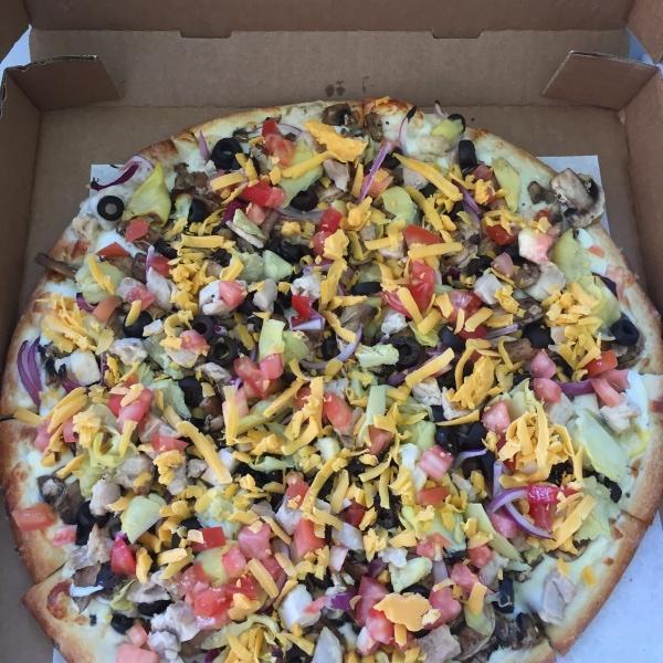 Artichoke Veggie Pizza · Garlic Alfredo, mozzarella cheese, mushrooms, olives, artichoke hearts, red onions, fresh tomatoes and cheddar cheese. All pizza crusts are brushed with butter sauce.