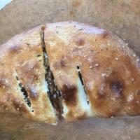 Calzone · Marinara sauce, mozzarella cheese, ricotta cheese and choice of 2 toppings, brushed with but...