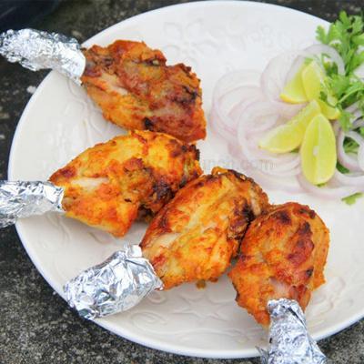 Tangdi Kabob · Tender bone - in chicken, marinated with exotic tandoori spices, roasted in clay oven, served with mint chutney and onion salad.