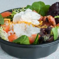 Salad Bowl · Fresh salad greens topped with your  favorite chili (con carne or vegan veggie), tomatoes, o...