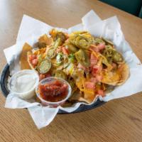 Nachos · Tortilla chips, covered with beef, nacho cheese, lettuce and tomatoes. Served with salsa and...
