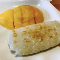 Mango with Sweet Sticky Rice · Typical Thai dessert of sweet sticky rice topped with house special coconut milk sauce and s...